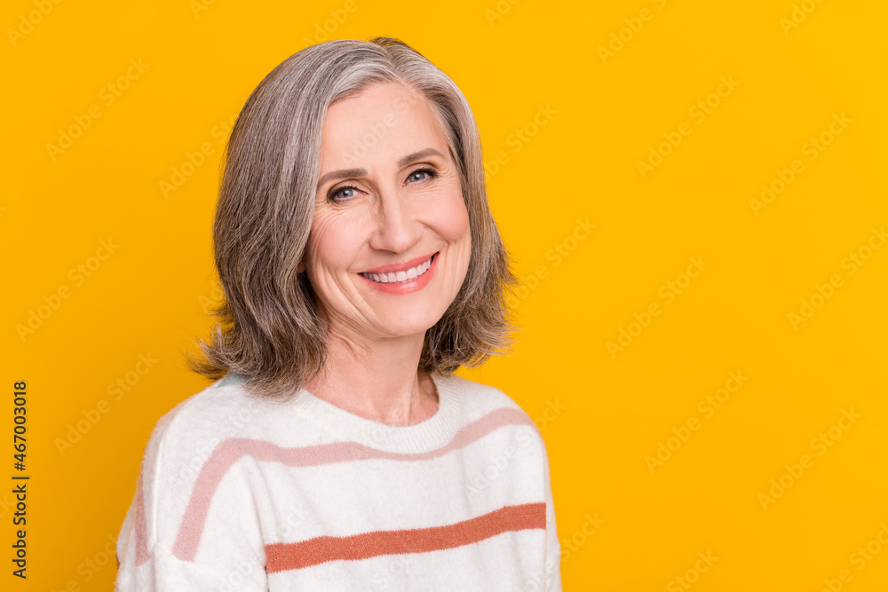 Portrait of attractive cheerful content grey-haired woman copy blank place space advert isolated over bright yellow color background Portrait of attractive cheerful content grey-haired woman copy blank place space advert isolated over bright yellow color background