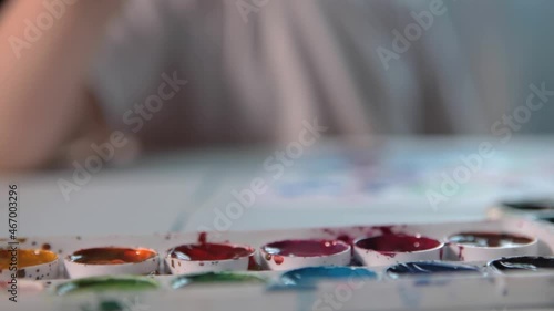 Wallpaper Mural A boy draws with paints at a table in his room. High quality FullHD footageA boy draws with paints at a table in his room. Torontodigital.ca