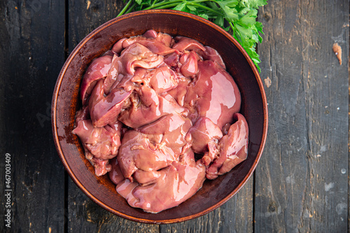 raw chicken liver offal piece meal snack on the table copy space food background rustic. top view keto or paleo diet photo
