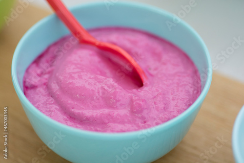 Homemade pink Tahini and beetroots sauce, in a colorful turquoise bowl, close up view