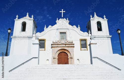 Beautiful Algarve church situated in Alcantarilha with dark blue sky as background. photo