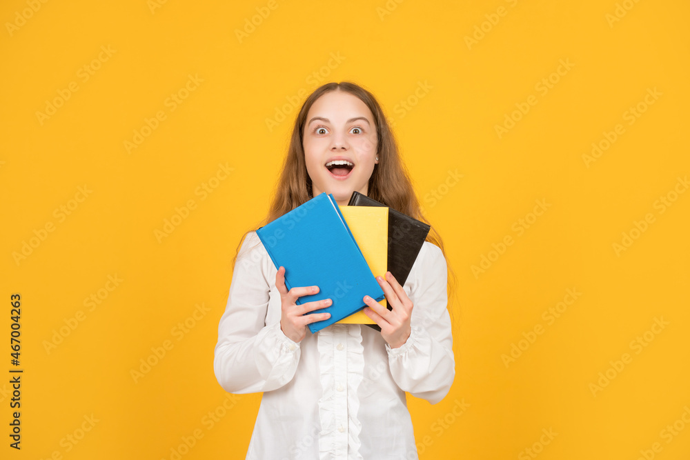 amazed child hold school book on yellow background, study amazed child hold school book on yellow background, study
