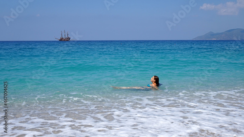  a girl swims in the blue sea      © Va_Ko