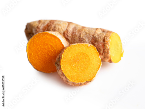 Turmeric root and slices isolated on white background. Clipping path. Tumeric, curcuma, curcumin close up.