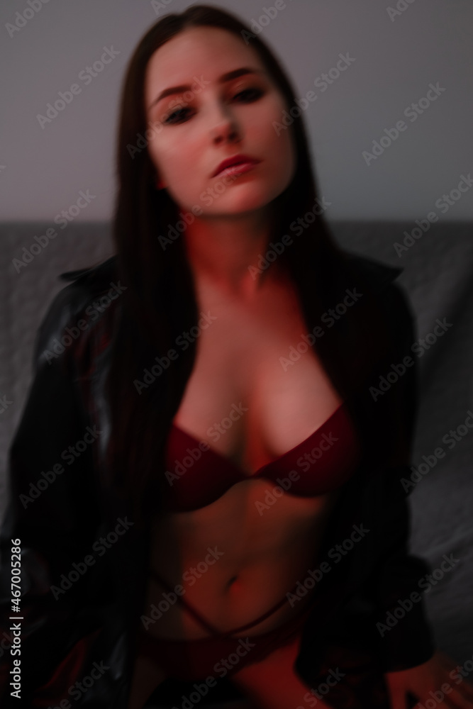 portrait of brunette woman in red underwear in dark grey room portrait of brunette woman in red underwear in dark grey room