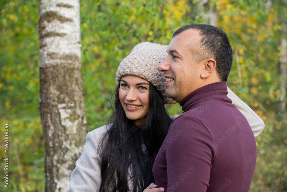 Beautiful young couple in autumn forest on a sunny day Beautiful young couple in autumn forest on a sunny day
