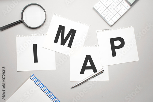 magnifier,calculator, pen and paper sheet with text imap photo
