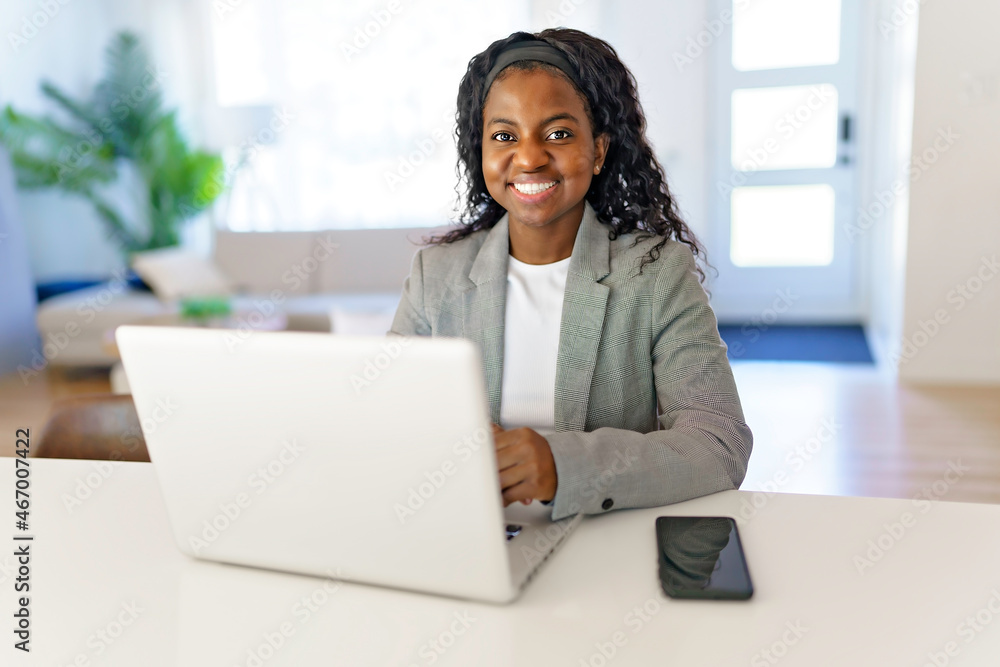 Portrait of a beautiful young woman with laptop and cellphone at home Portrait of a beautiful young woman with laptop and cellphone at home