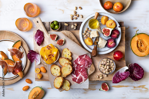 Flat-lay of appetizers table with italian antipasti snacks. Holiday gathering, wine and snacks party. Brushetta or authentic traditional spanish tapas set over wooden background.