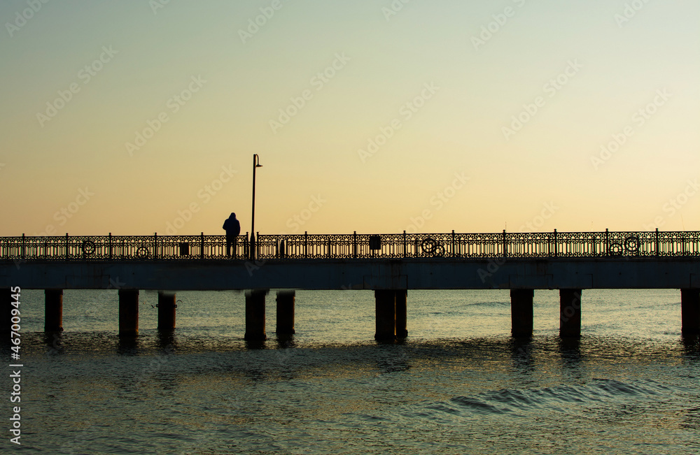 Man standing alone on the pier.Loneliness.