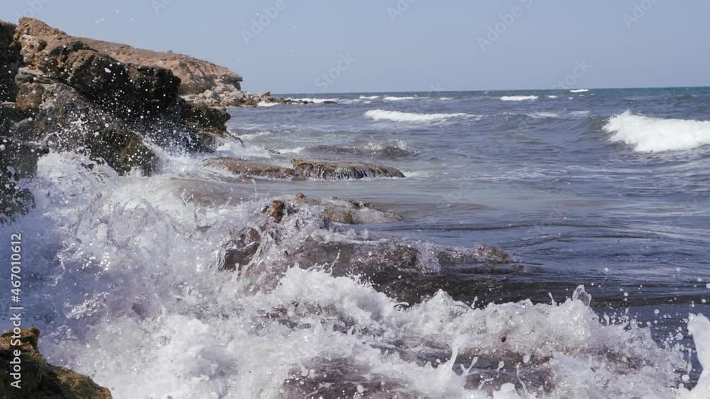 Sea waves break on the coastal rocks. Sea waves break on the coastal rocks.