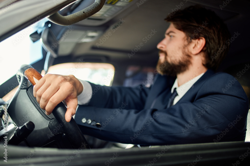 bearded man in a suit in a car a trip to work success service rich