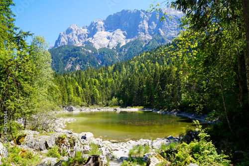 a picturesque emerald green little lake near lake Eibsee by the foot of mountain Zugspitze in Bavaria (Garmisch, Germany)