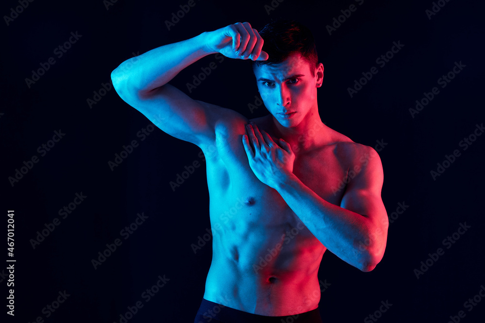 sexy athletes with a pumped-up torso gesturing with hands on an isolated background and nude body model