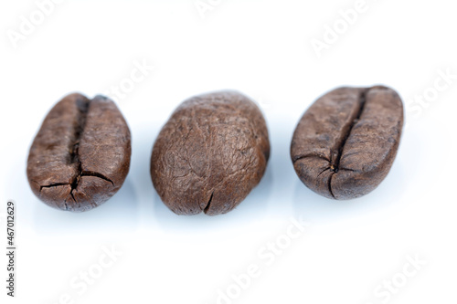 Macro photography of three coffee beans isolated on white