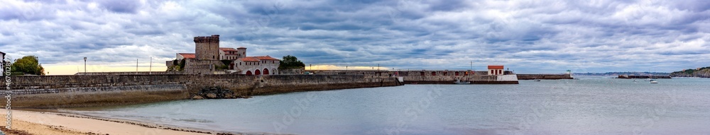 Panoramic view of the fort of Sokoa, French Basque country, from the beach of the port. You can see the fort complete with its houses below, the entire boardwalk at the entrance of the port, with its 