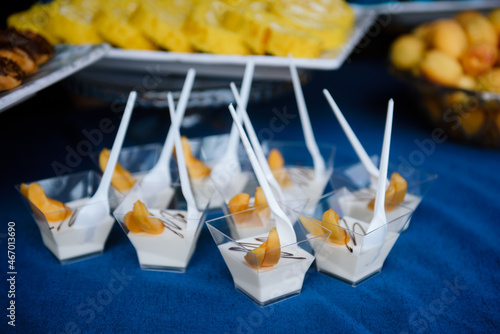 Individual panna cotta desserts on a party table photo