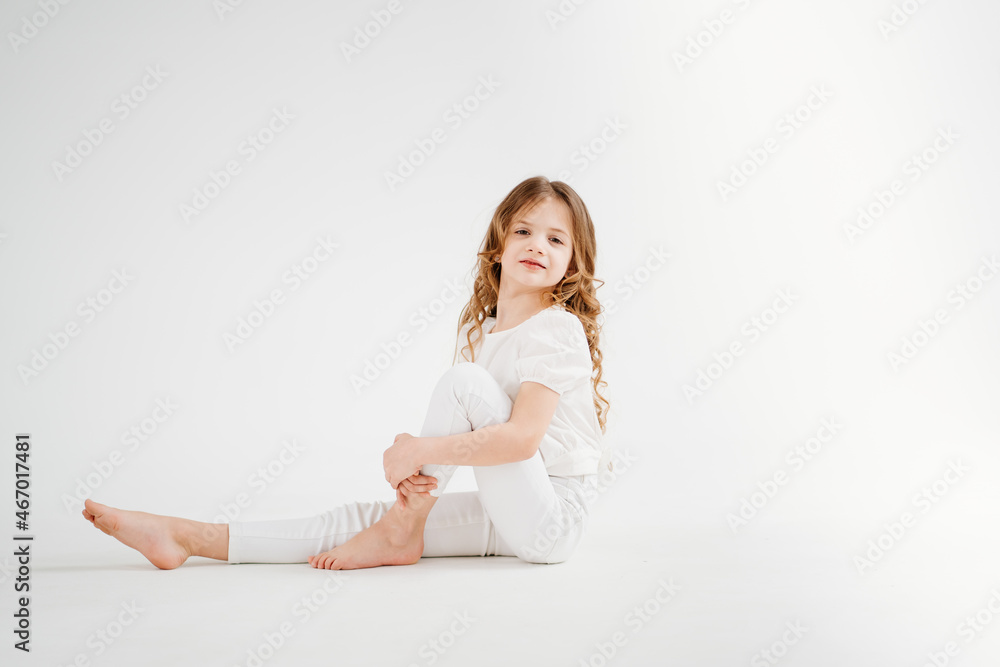barefoot little girl with long hair in white clothes.shampoo for children's hair barefoot little girl with long hair in white clothes.shampoo for children's hair