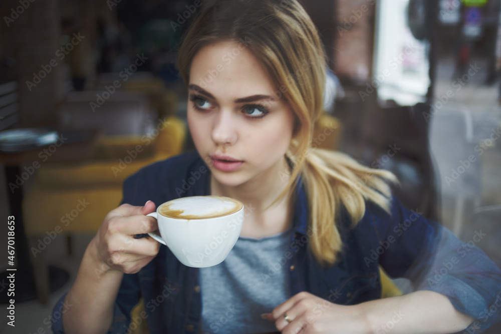 pretty woman in a cafe a cup of drink communication relaxation pretty woman in a cafe a cup of drink communication relaxation