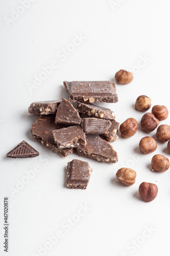 Dark chocolate and peeled hazelnuts. Chocolate with nuts
