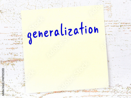 Yellow sticky note on wooden wall with handwritten word generalization photo