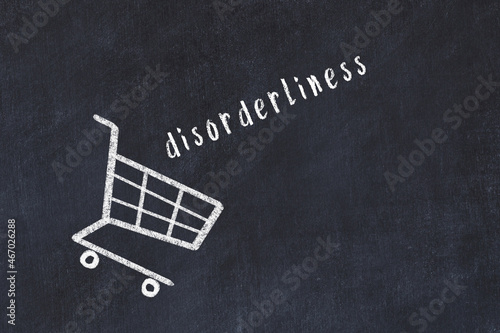 Chalk drawing of shopping cart and word disorderliness on black chalboard. Concept of globalization and mass consuming photo