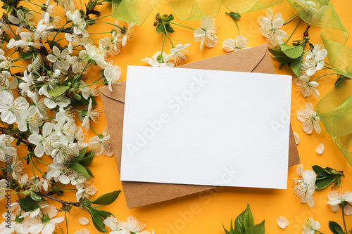 postcard mockup. Frame from flowering spring branches and white blank for the text. congratulation. invitation