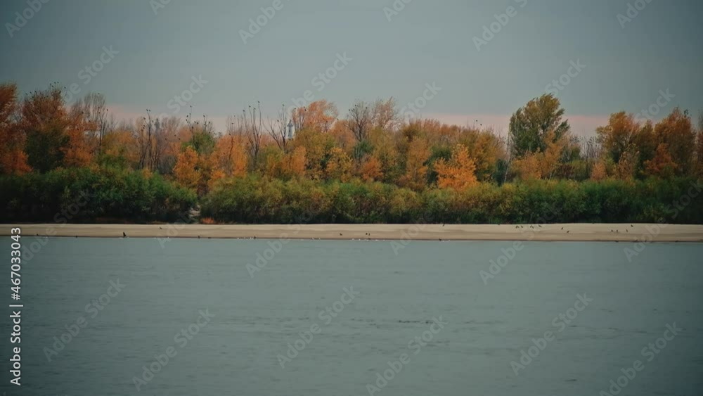 Volga River near the Astrakhan in autumnal time. The bright colors of golden autumn painted the leaves of the trees in yellow and red colors. Volga River near the Astrakhan in autumnal time. The bright colors of golden autumn painted the leaves of the trees in yellow and red colors.