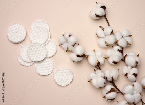 White cotton sponges on beige background. Design for the beauty, medicine and cosmetics industry