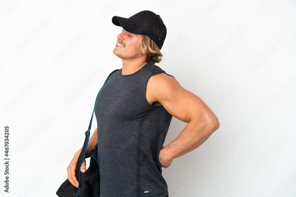Young sport man with sport bag isolated on white background suffering from backache for having made an effort