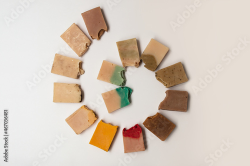 Handmade organic soaps on white background, top view.