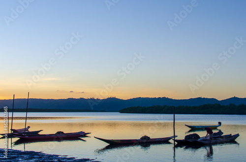 Canoes and boats docked on the bank of the grand Paraguacu river. photo