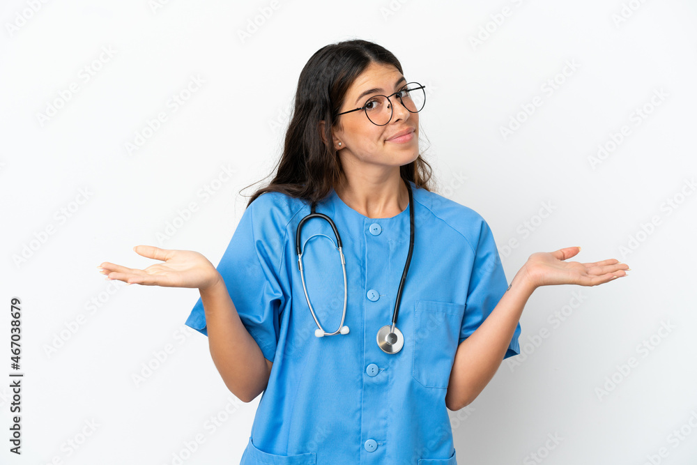 Young surgeon doctor caucasian woman isolated on white background having doubts while raising hands Young surgeon doctor caucasian woman isolated on white background having doubts while raising hands