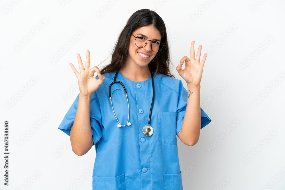 Young surgeon doctor caucasian woman isolated on white background showing an ok sign with fingers Young surgeon doctor caucasian woman isolated on white background showing an ok sign with fingers