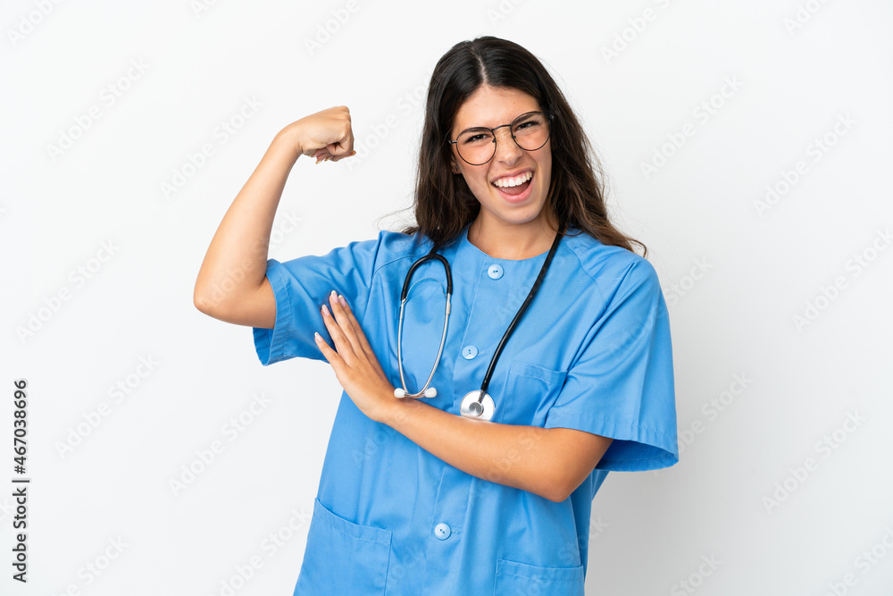 Young surgeon doctor caucasian woman isolated on white background doing strong gesture Young surgeon doctor caucasian woman isolated on white background doing strong gesture