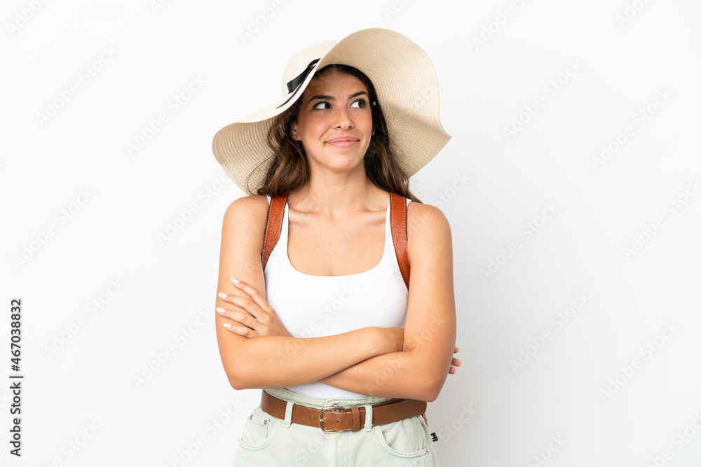 Young caucasian woman wearing a Pamela in summer holidays isolated on white background making doubts gesture while lifting the shoulders Young caucasian woman wearing a Pamela in summer holidays isolated on white background making doubts gesture while lifting the shoulders