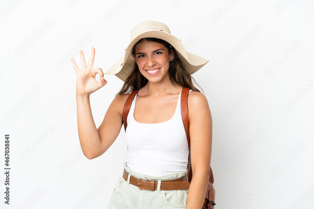Young caucasian woman wearing a Pamela in summer holidays isolated on white background showing ok sign with fingers Young caucasian woman wearing a Pamela in summer holidays isolated on white background showing ok sign with fingers