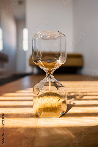 Sand watch close up on a wooden background