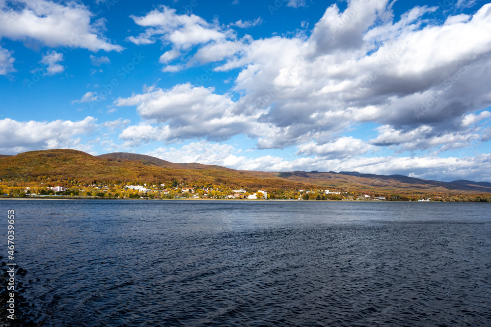 Beautiful view of a part of the panorama of Lake Zemplínska Šírava with a forest mountain range in autumn