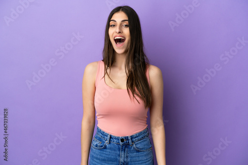 Young caucasian woman isolated on purple background with surprise facial expression © luismolinero
