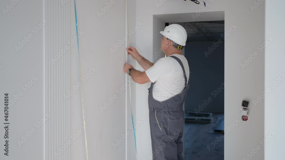 A male electrician installs an LED strip to illuminate the walls in the smart home system. Installation Check Lighting A male electrician installs an LED strip to illuminate the walls in the smart home system. Installation Check Lighting