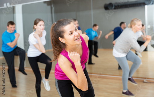 Fototapeta Naklejka Na Ścianę i Meble -  Cheerful young woman enjoying active dances in modern dance studio..