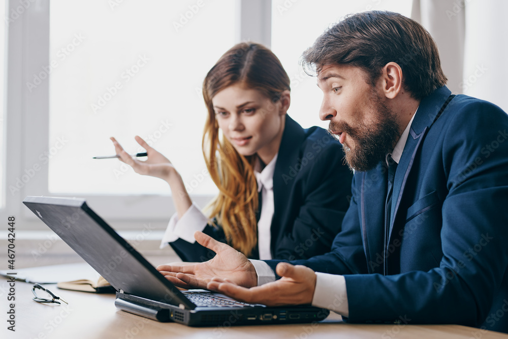 managers in the office in front of a laptop career work technologies managers in the office in front of a laptop career work technologies