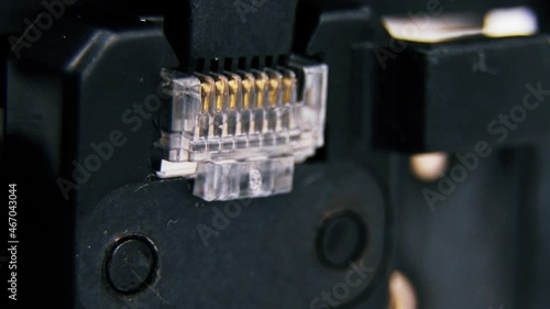 Compression of the Internet connector using a crimper for crimping RJ 45. Internet Network Connector, rj45.Crimping of a unified connector used in telecommunications. Unified connector 8P8C. photo