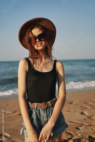 woman in trendy summer clothes by the ocean vacation sun
