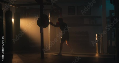 Boxer trains in boxing gym in the early morning. Shot in 8k. photo