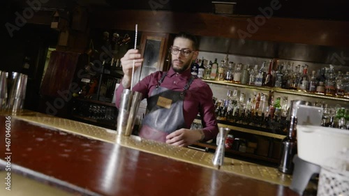 A bartender spins his spoon in the air photo