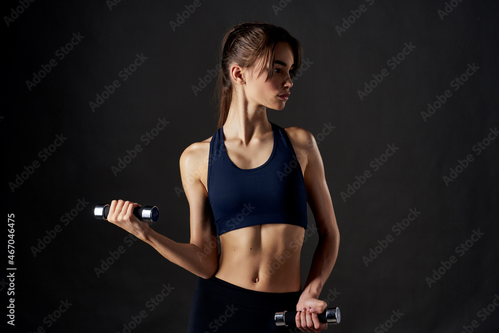 pretty woman fitness exercise dumbbells in the hands of Strong isolated background pretty woman fitness exercise dumbbells in the hands of Strong isolated background