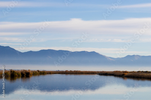 early morning fog over a lake in the mountains