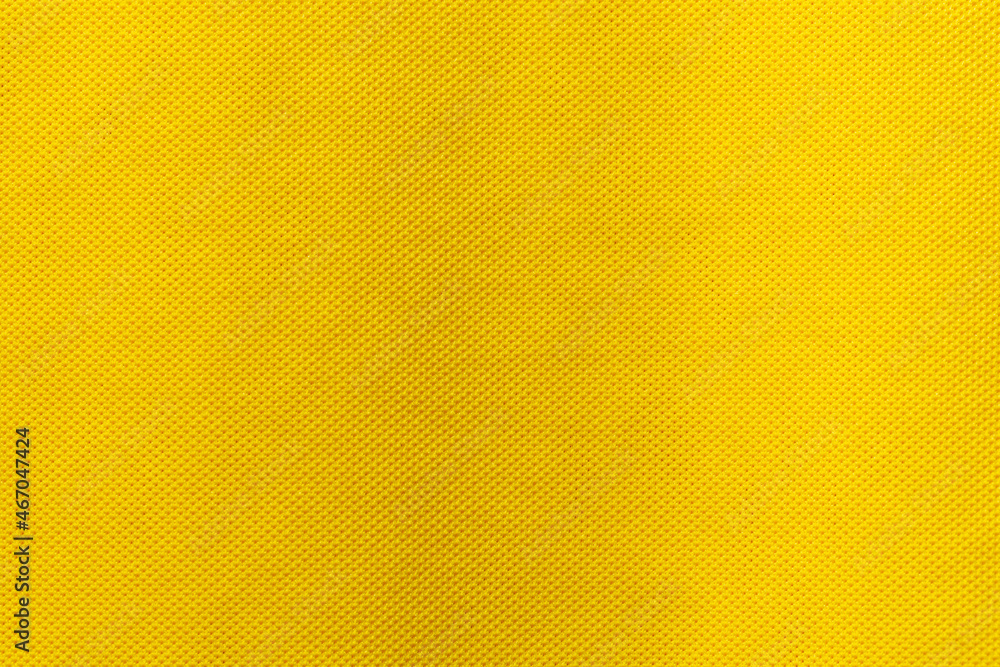 Yellow color sports clothing fabric football shirt jersey texture and textile background.